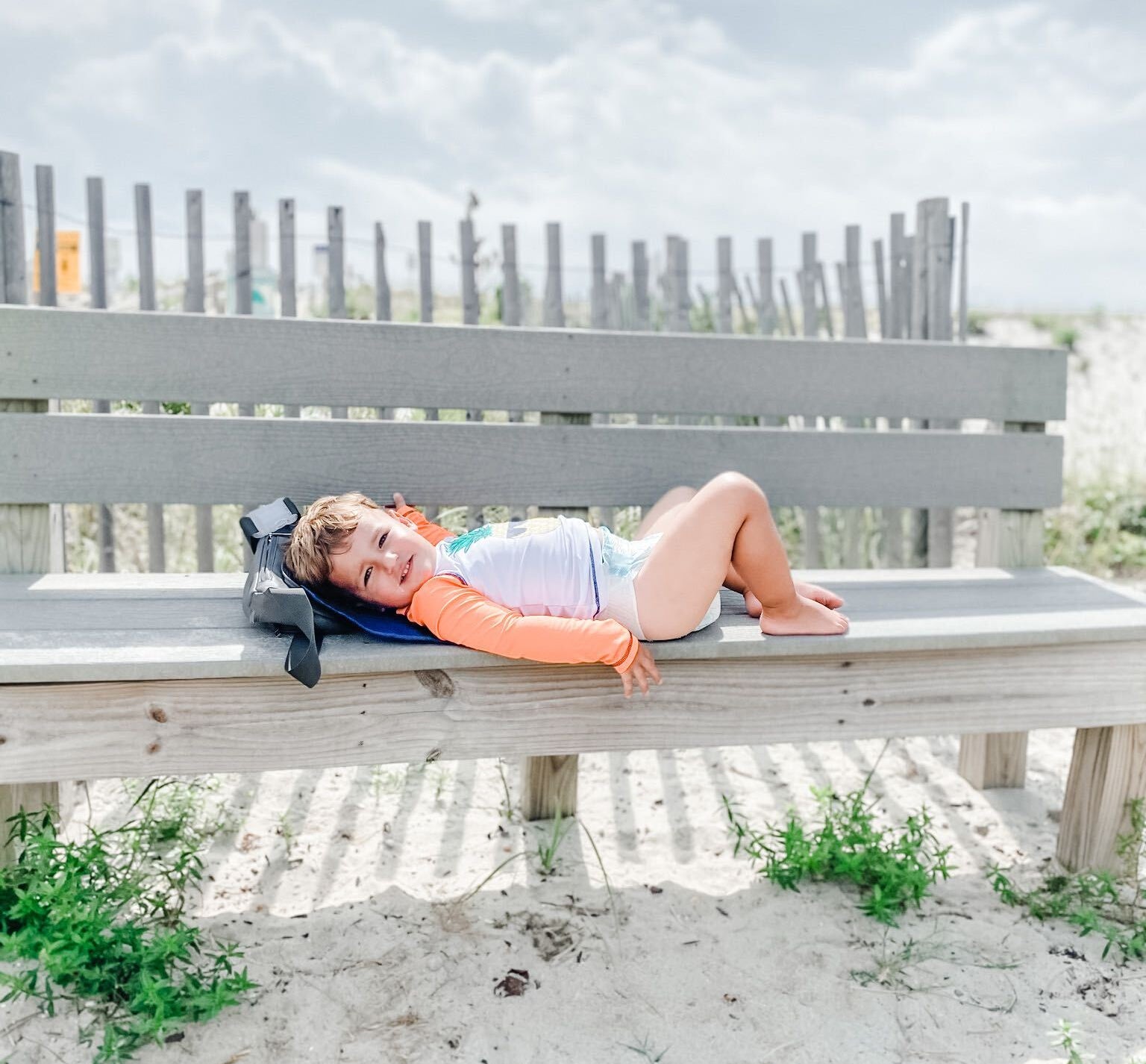 Toddler on diaper changing pad at the beach